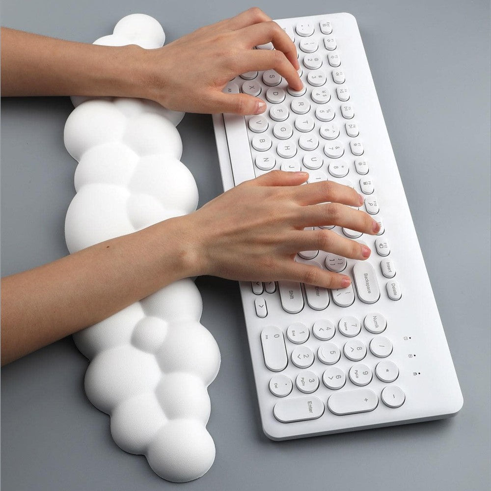 Hände auf der Cloud-Handgelenkauflage vor einer weissen Tastatur